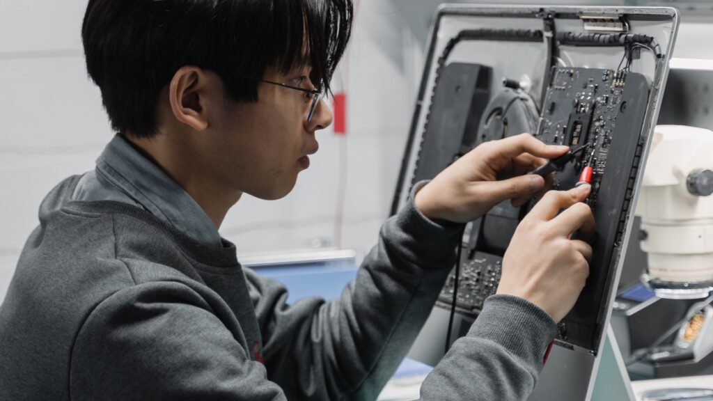 Guy repairing a computer